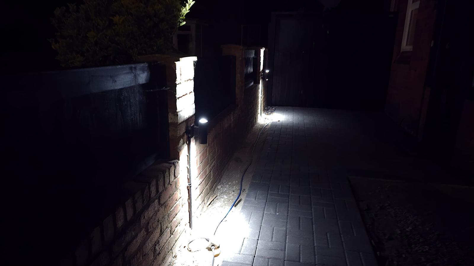 Gate pillar lighting installation lit up at night — Wirral electrician